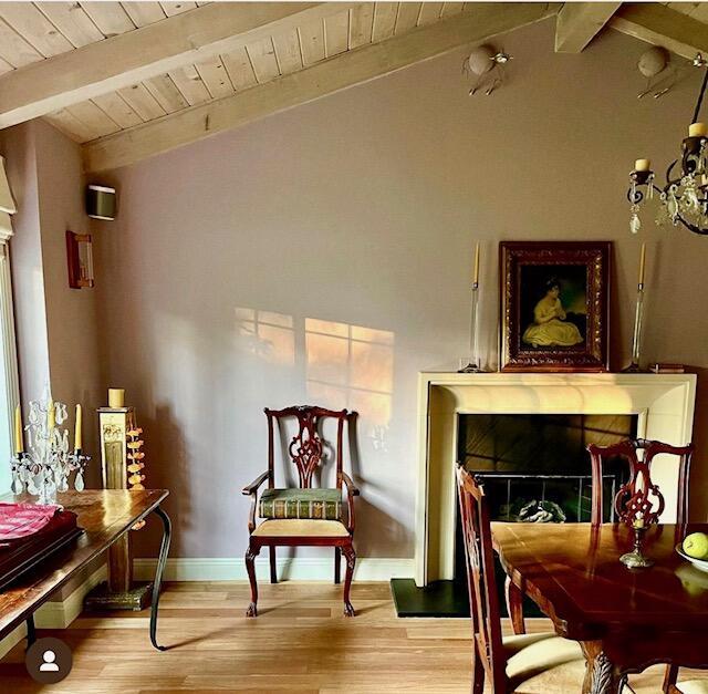 sitting room with high vaulted ceiling, wood ceiling, beam ceiling, and light hardwood / wood-style flooring