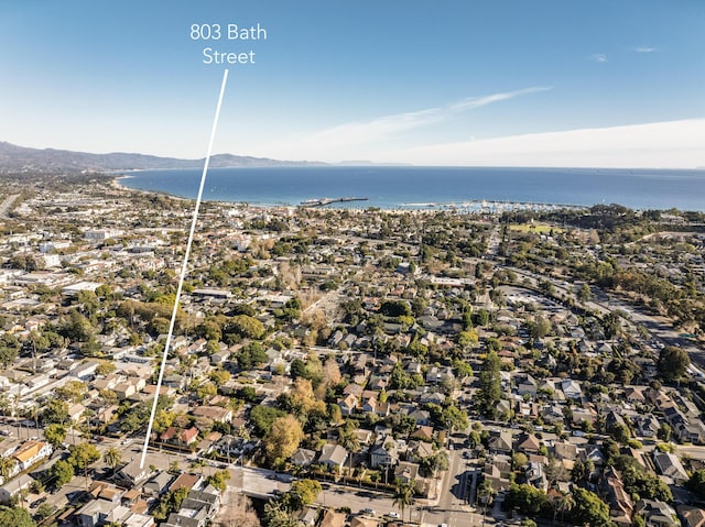 birds eye view of property with a water and mountain view