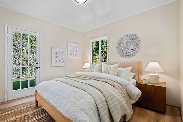 bedroom with hardwood / wood-style flooring and access to outside