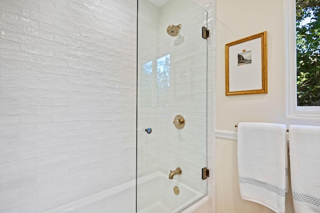 bathroom featuring shower / bath combination with glass door