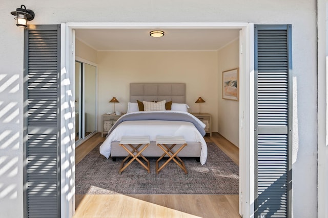 bedroom featuring light hardwood / wood-style flooring and ornamental molding