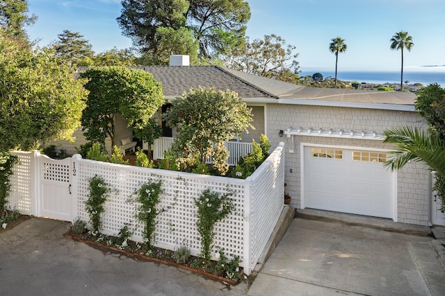 view of front of home with a water view and a garage