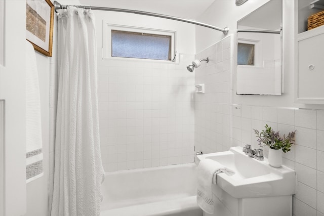 bathroom with decorative backsplash, tile walls, and shower / bath combo