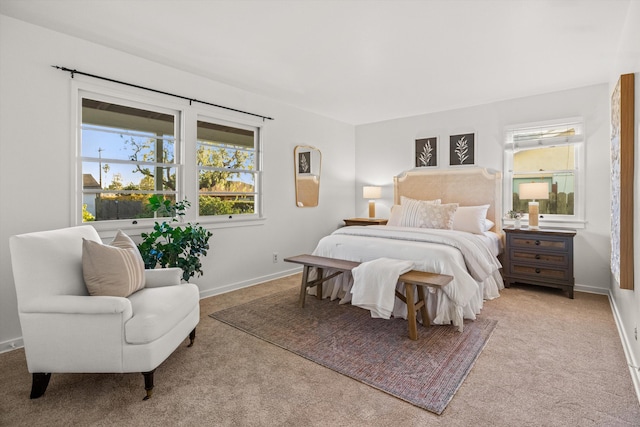 bedroom with light colored carpet and multiple windows