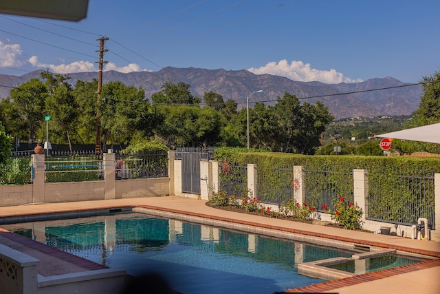 view of swimming pool with a mountain view