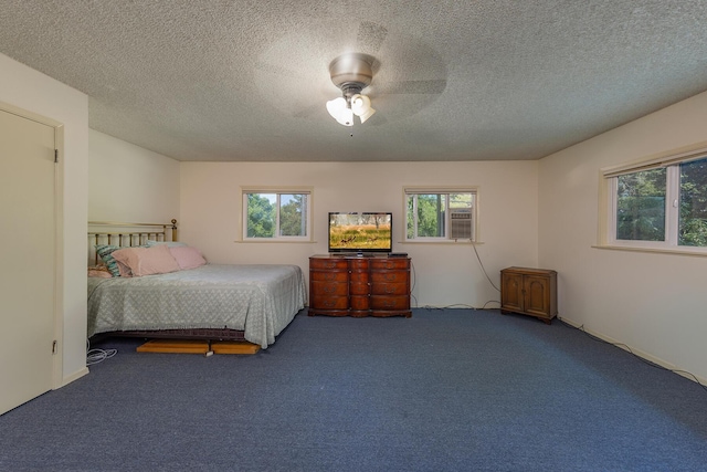 carpeted bedroom featuring a textured ceiling and ceiling fan