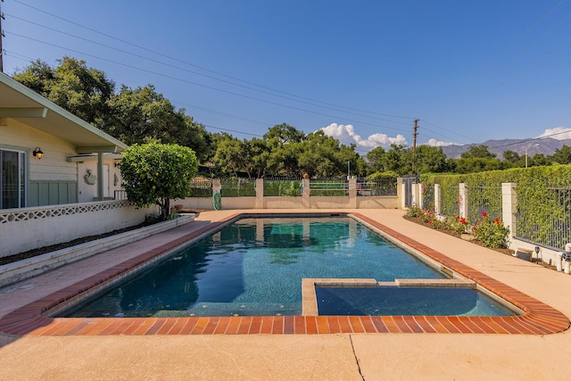 view of swimming pool with a mountain view and a patio area