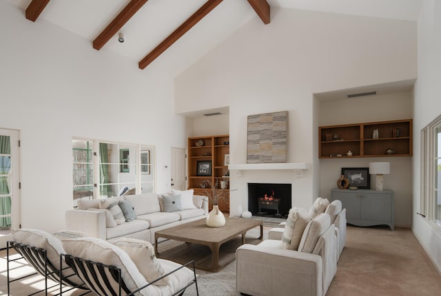 living room featuring beam ceiling, high vaulted ceiling, and light colored carpet