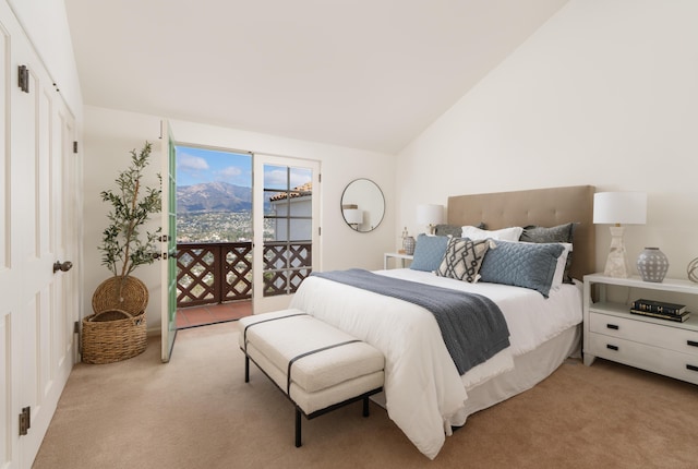 carpeted bedroom featuring lofted ceiling and access to exterior