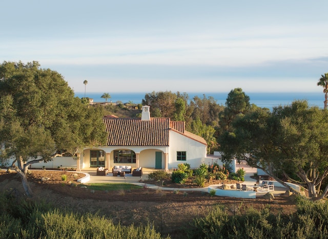 back of property featuring an outdoor living space and a patio