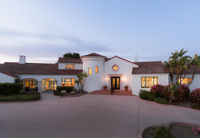 mediterranean / spanish-style home with french doors