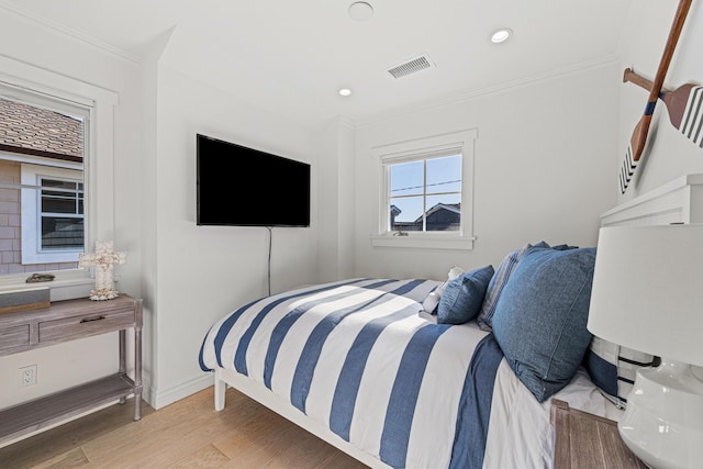 bedroom featuring light hardwood / wood-style flooring and ornamental molding