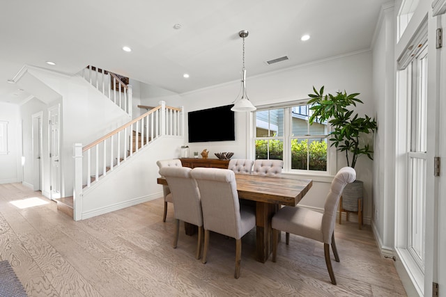 dining room featuring ornamental molding and light hardwood / wood-style floors