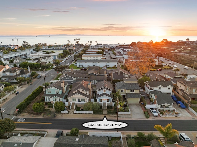 aerial view at dusk with a water view