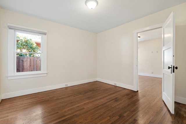 spare room featuring dark hardwood / wood-style floors