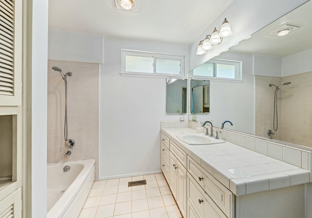 full bathroom with shower / bath combination, plenty of natural light, vanity, and tile patterned floors