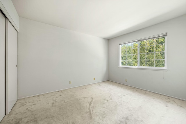 unfurnished bedroom featuring a closet and carpet flooring