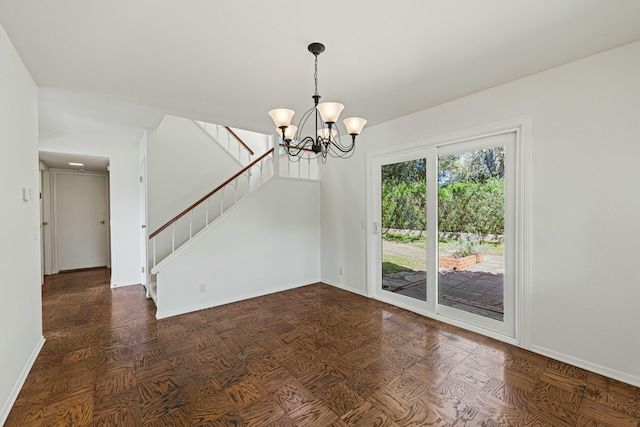 unfurnished room featuring baseboards, stairway, and a chandelier