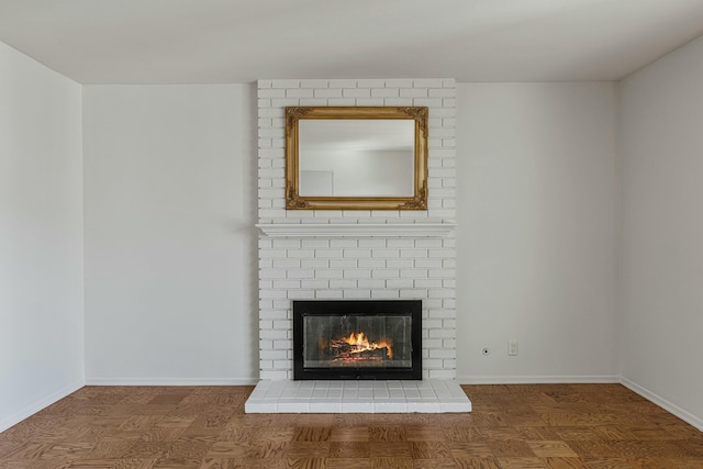 interior space with a brick fireplace and baseboards