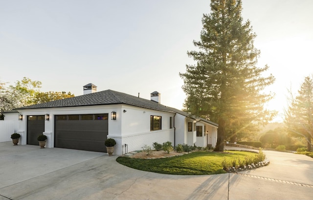 property exterior at dusk featuring a garage