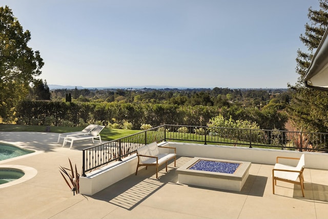 view of patio / terrace featuring an outdoor fire pit