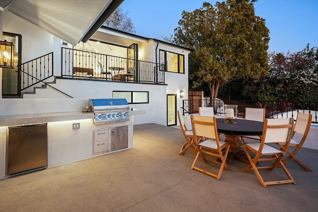 patio terrace at dusk featuring area for grilling and grilling area