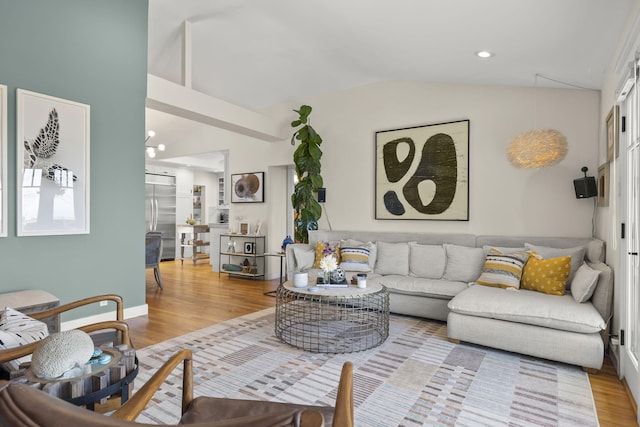 living room with vaulted ceiling and light hardwood / wood-style floors