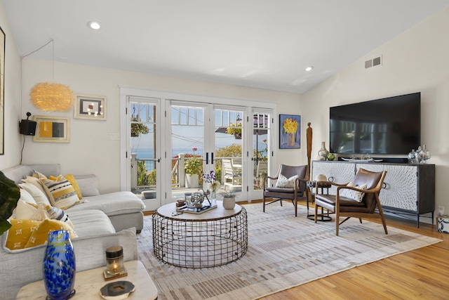 living room featuring vaulted ceiling and hardwood / wood-style floors