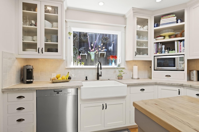 kitchen with white cabinetry, stainless steel appliances, and sink