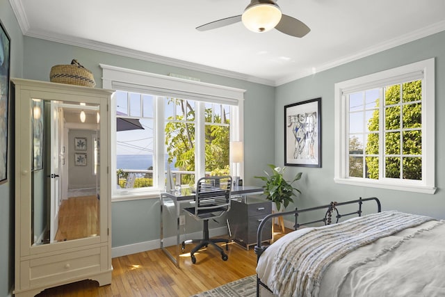 bedroom with ornamental molding, ceiling fan, and light wood-type flooring