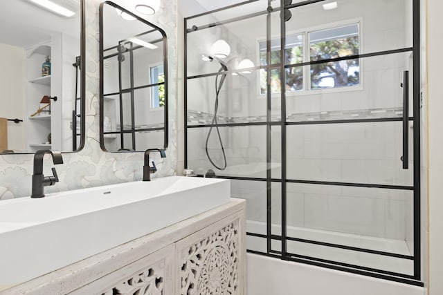 bathroom with enclosed tub / shower combo and vanity