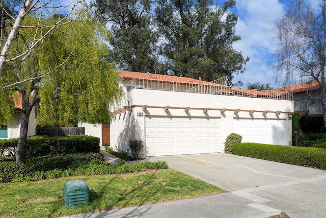 view of front of home featuring a balcony and a garage