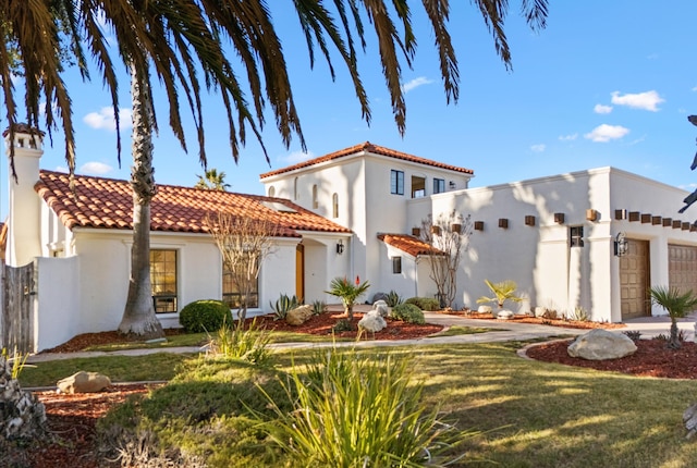 view of front of house with a garage and a front lawn