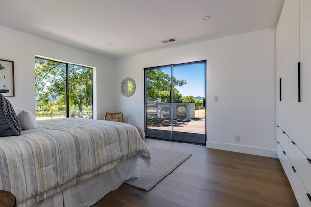 bedroom featuring access to outside and dark hardwood / wood-style flooring