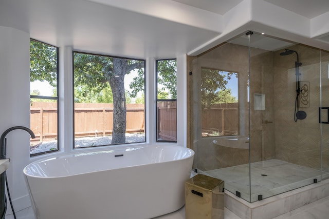 bathroom featuring shower with separate bathtub