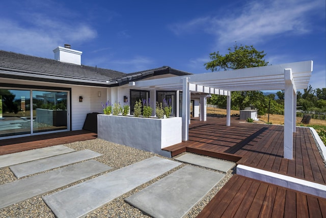 wooden terrace featuring a pergola and a patio