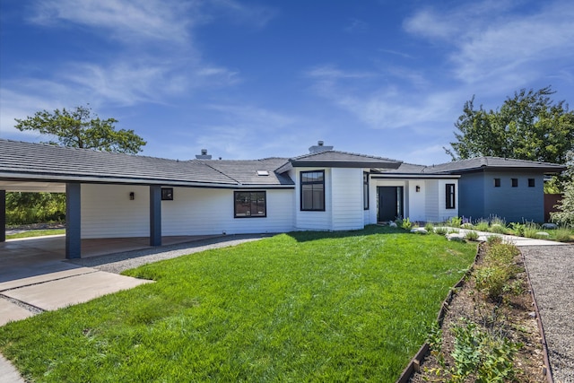 single story home with a front yard and a carport