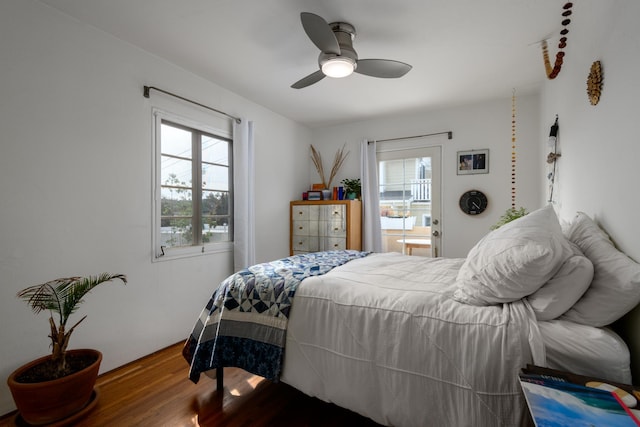 bedroom with multiple windows, hardwood / wood-style floors, and ceiling fan