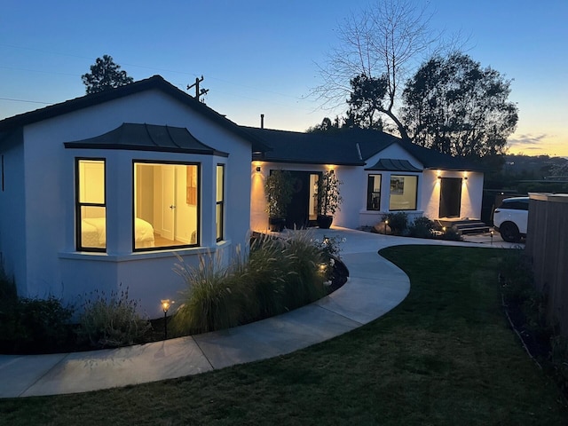 view of front of property with a lawn