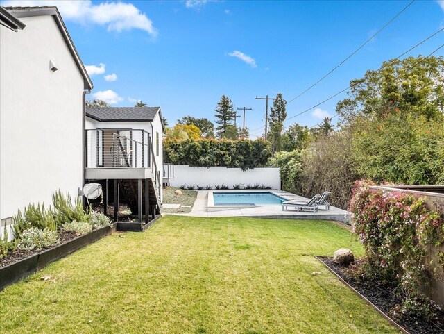 view of yard with a deck, a patio, a fenced backyard, stairs, and a fenced in pool