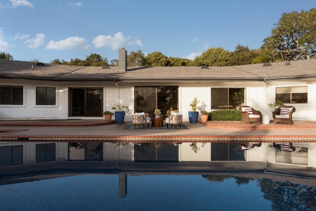 rear view of property with an outdoor hangout area and a patio area