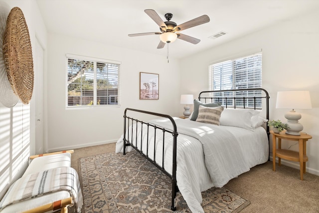 bedroom featuring multiple windows, carpet floors, and ceiling fan