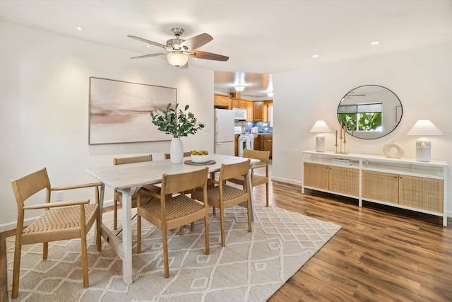 dining room with dark wood-type flooring and ceiling fan