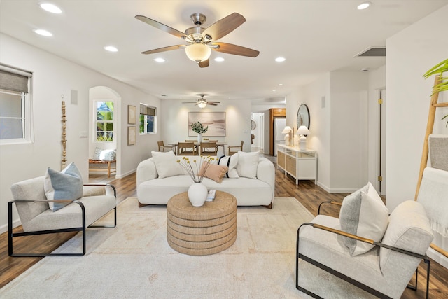 living room with ceiling fan and light wood-type flooring