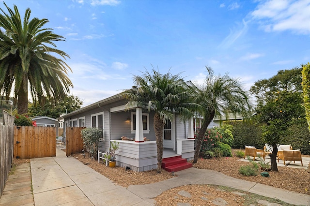 view of front of house with covered porch and fence