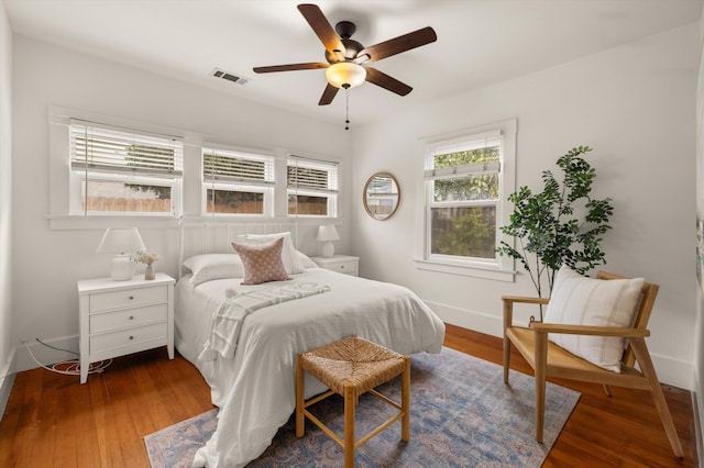 bedroom featuring ceiling fan and dark hardwood / wood-style flooring