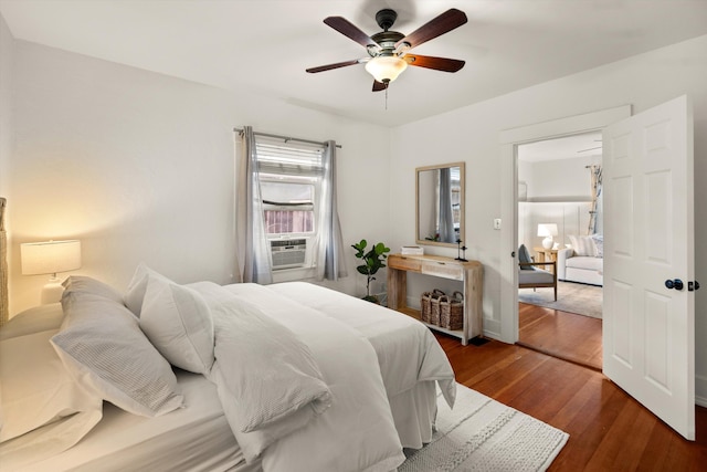 bedroom with dark hardwood / wood-style floors and ceiling fan