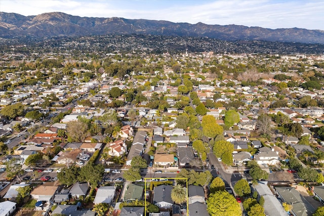 drone / aerial view featuring a residential view and a mountain view