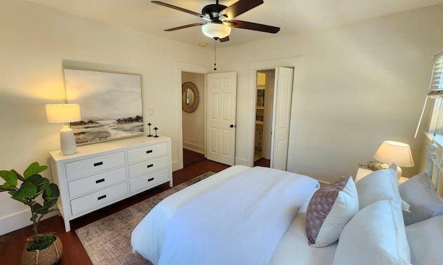 bedroom with ceiling fan, baseboards, and dark wood finished floors