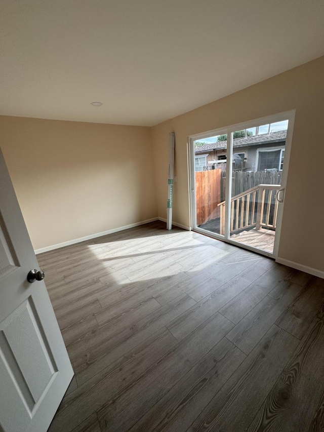 spare room featuring wood-type flooring